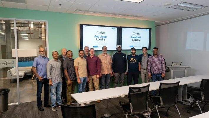 Dallas/Fort Worth Postgres meetup attendees in front of screens displaying the Floci logo